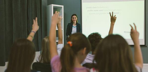 Woman giving a presentation to a classroom